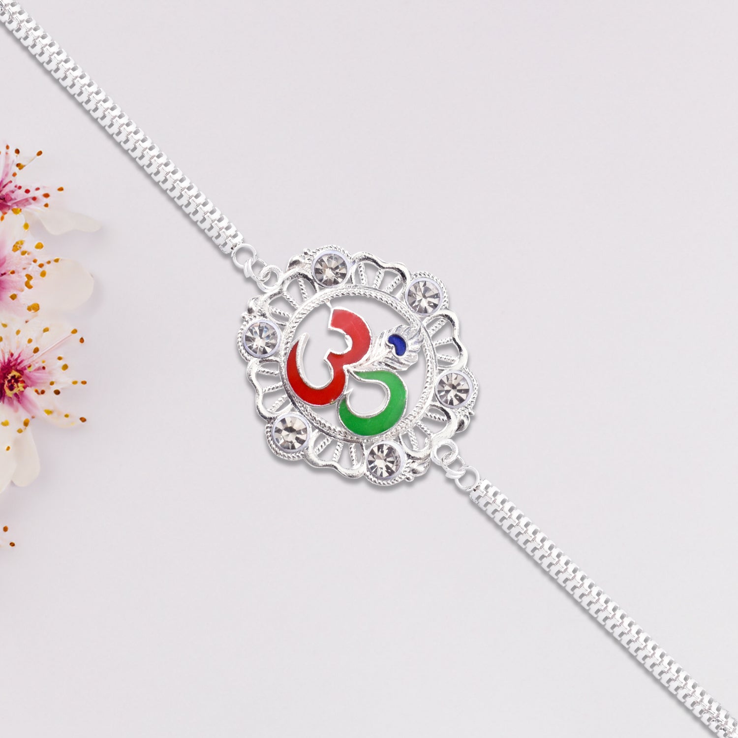 Silver Om Rakhi With Stone Embellishments Silver Om Rakhi With Stone Embellishments